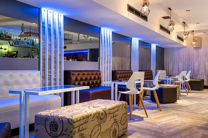 Modern stylish lounge area with contemporary furniture and ambient lighting for business or social gatherings.