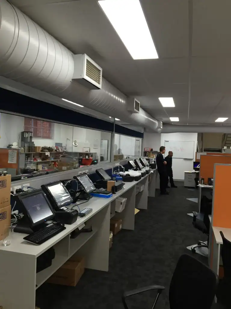 Electronically equipped office workspace with modern devices and equipment.