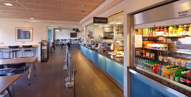 Food court with beverage fridge and seating area at 21st Century Business Equipment cafeteria, modern dining space in Australia.