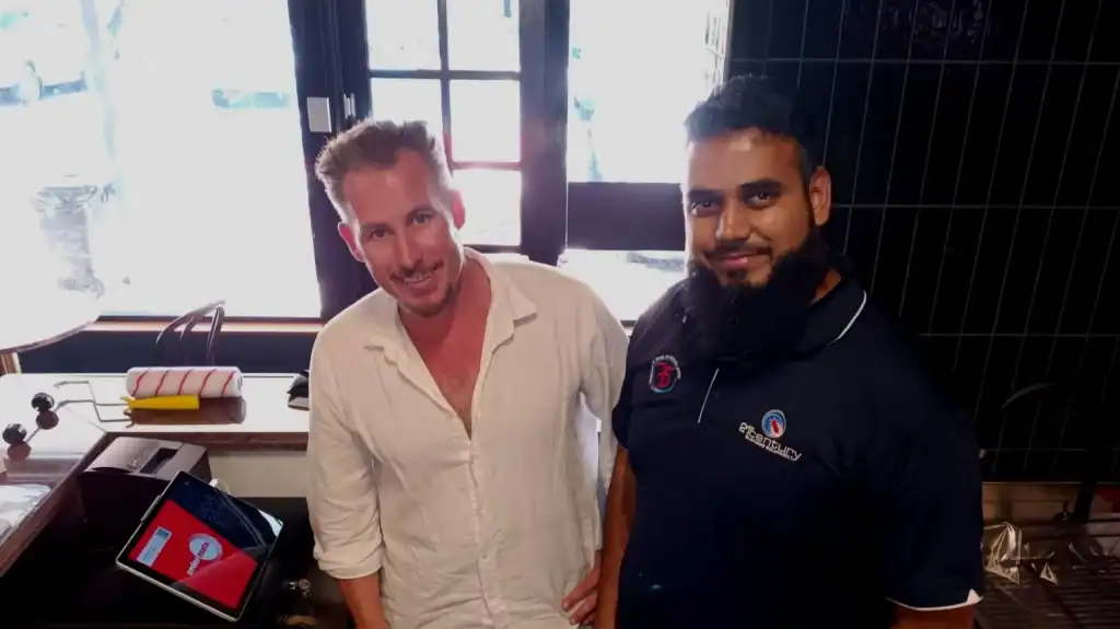 21st Century Business Equipment staff smiling at the store counter.