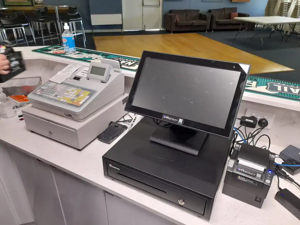 Efficient POS system setup with cash register, touchscreen monitor, and barcode scanner.