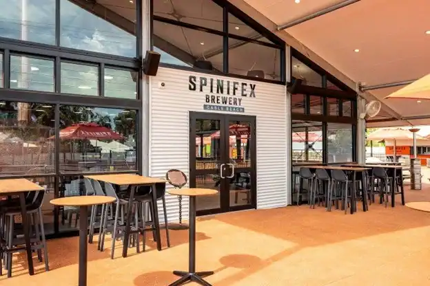 Spinfex Brewery exterior with patio seating, modern design, and outdoor ambiance.