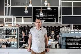 21st Century Business Equipment store interior with staff and coffee shop setup.
