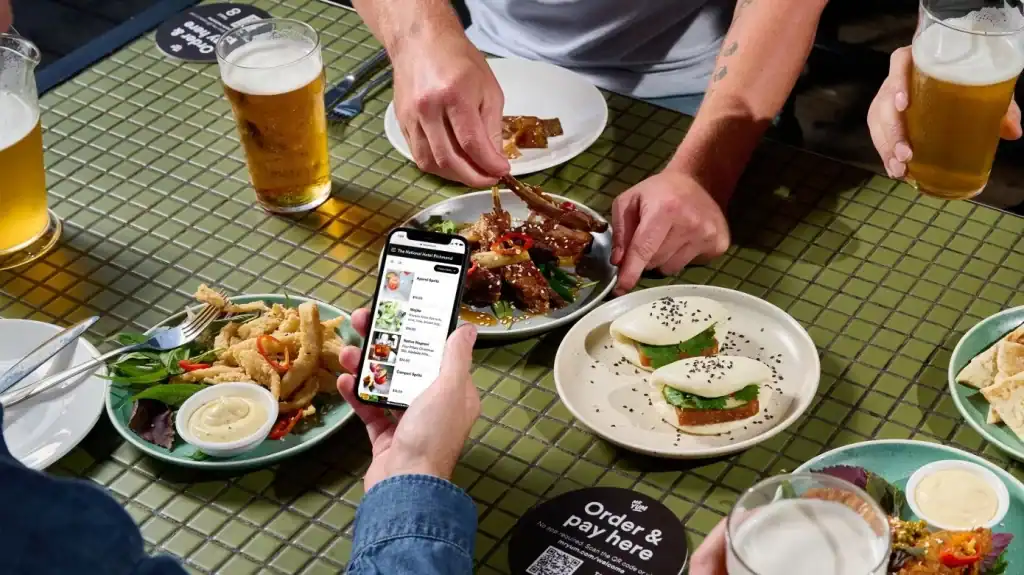 Fresh food and drinks served at a restaurant with people enjoying their meal.