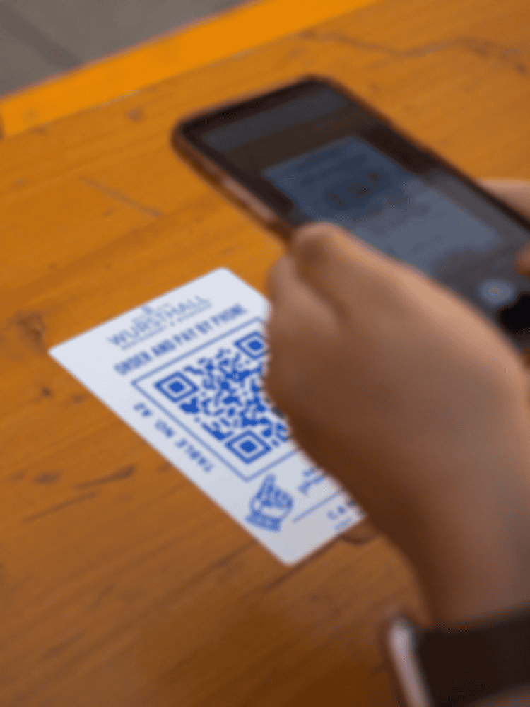 QR code being scanned on a printed sheet with a smartphone.