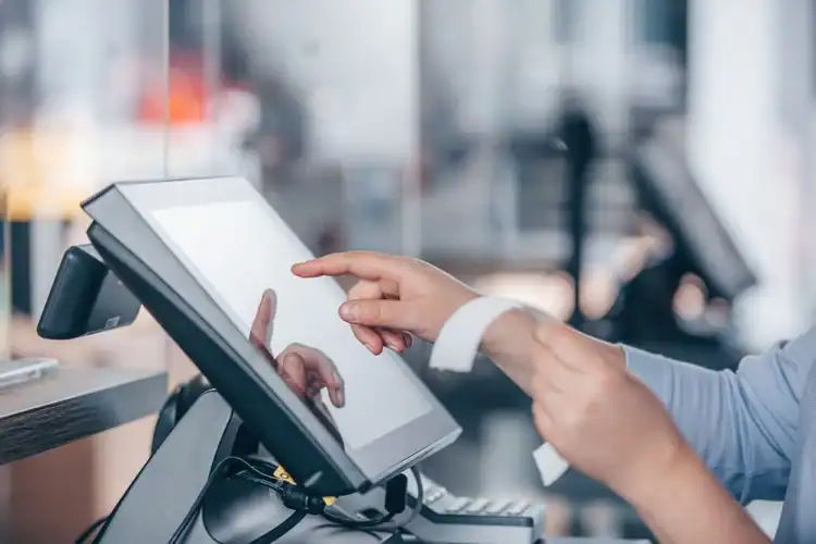 Touchscreen point of sale system used for business transactions in a modern retail environment.