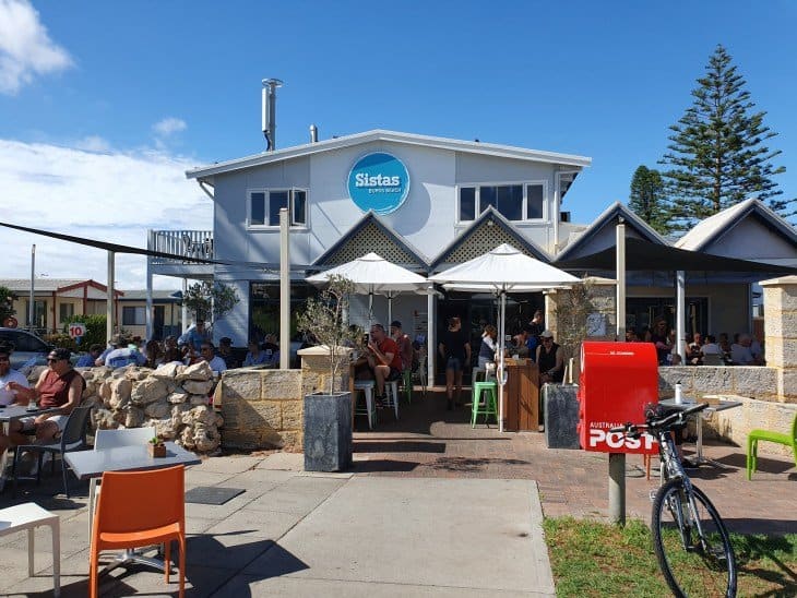 21st Century Business Equipment storefront with outdoor dining area, vibrant community space, and clear signage.