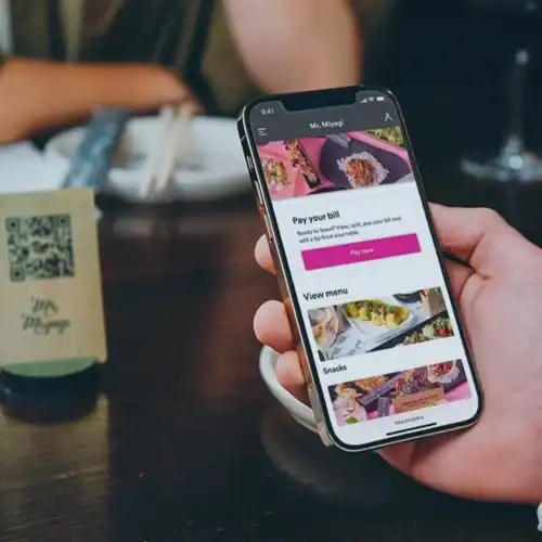 Pay bill online using smartphone at restaurant or cafe.