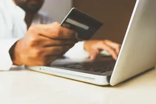High-quality office equipment, including laptops and credit cards, for modern business transactions.