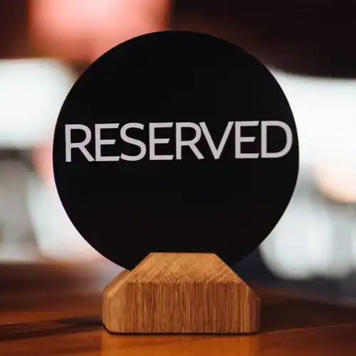 Reserved sign on table in a cafe or restaurant setting.