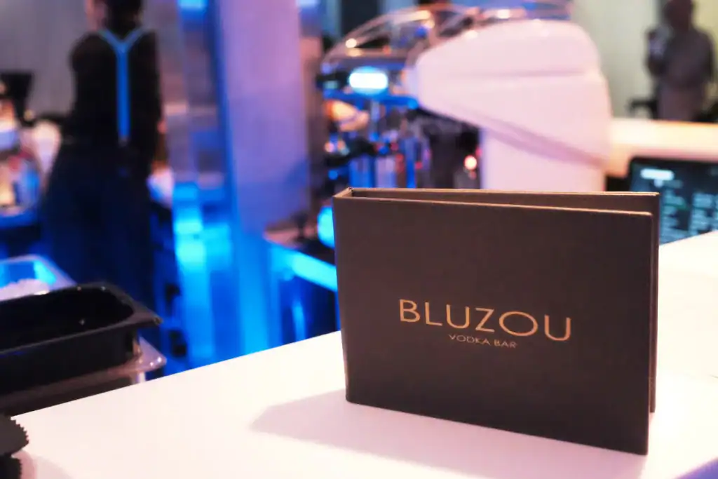 Bluzo vodka bar promotional sign at trendy nightclub.