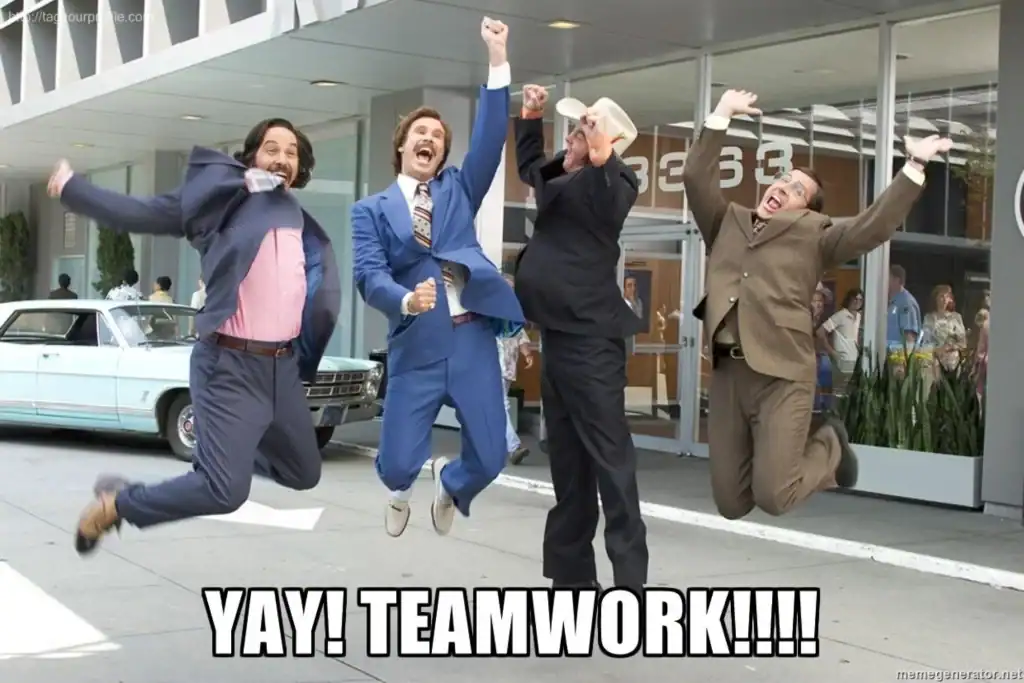 Jumping colleagues celebrating teamwork outside office building, cheerful work environment, positive team spirit.