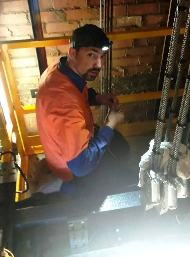 Man working with industrial equipment at 21st Century Business Equipment.