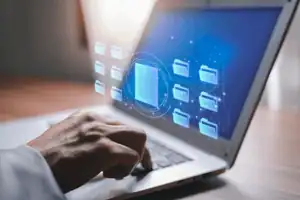 Laptop with digital business files interface on the screen.