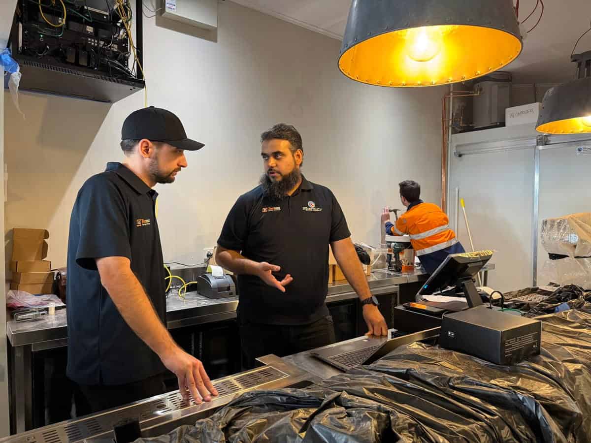 Professional technicians repairing office equipment at 21st Century Business.