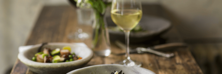 Elegant table setting with gourmet dishes and wine for fine dining.