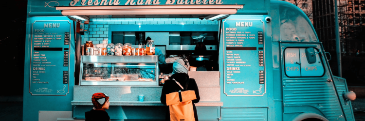 Fisherman's food truck serving fresh fish and chips in an urban setting.